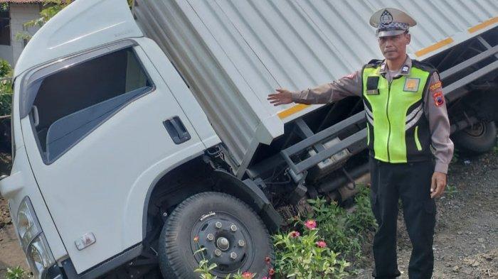 Personel Satlantas Polresta Cilacap melakukan olah TKP kecelakaan truk boks menabrak sepeda motor di Jalan Raya Jeruklegi Kulon, Cilacap pada Selasa (20/2/2024) siang.