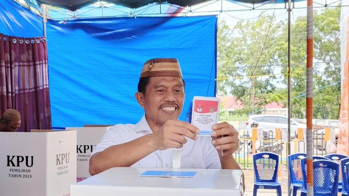 RONI IMRAN NYOBLOS - Calon Bupati Roni Imran nyonlos di TPS 003 desa Molingkapoto, Kecamatan Kwandang, Kabupaten Gorontalo Utara, Sabtu (19/4/2025).FOTO: Efriet Mukmim, TribunGorontalo.com