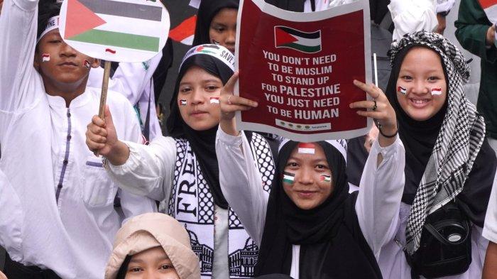 Massa melakukan long march Aksi Bela Palestina Keluarga Besar Persis Kota Bandung melintas di salah satu ruas jalan di Kota Bandung, Jawa Barat, Sabtu (25/11/2023).