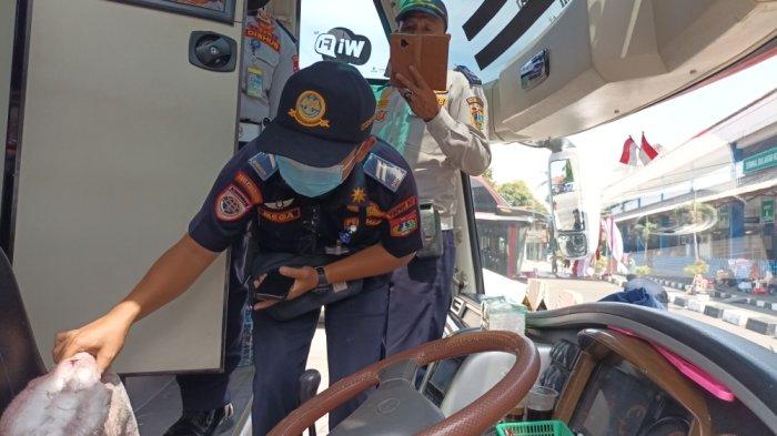 Petugas UP PKB Pulogadung saat melakukan ramp check atau pemeriksaan laik jalan bus AKAP di Terminal Kampung Rambutan, Jakarta Timur, Selasa (19/12/2023).