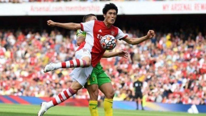 Pemain Arsenal Takehiro Tomiyasu berebut bola dengan pemain Norwich City dalam pertandingan Liga Premier, 11 September 2021.