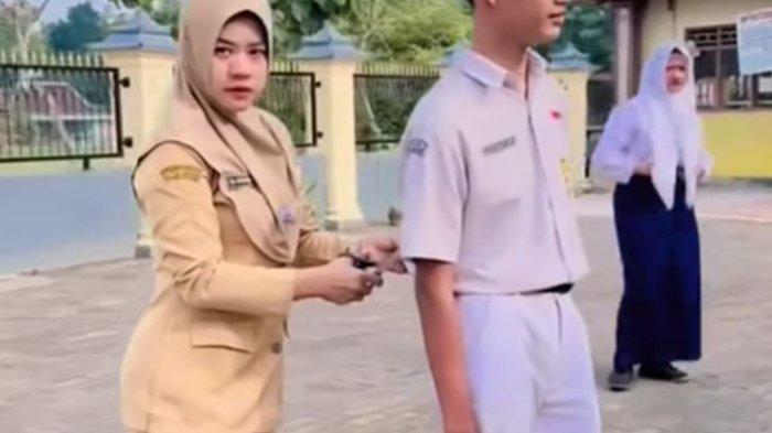 GUNTING SERAGAM - Tangkapan layar video seorang guru di Sragen sedang menggunting seragam siswa. Aksi guru tersebut menjadi viral dan menjadi perbincangan publik.