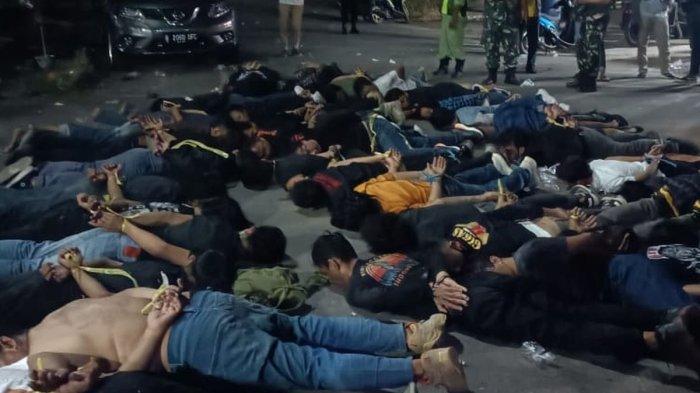 Puluhan orang yang diduga merupakan anggota organisasi yang ditangkap oleh aparat kepolisian di Jalan Raya Setu-Bantargebang, Kota Bekasi, Rabu (20/9/2023) malam. Belum diketahui penyebab dari bentrokan yang diduga terjadi antar ormas tersebut.