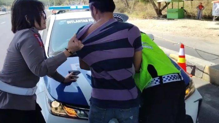 Kanit PJR 8 Jatim Suramadu, AKP Farida Ariyani berupaya menarik baju pengemudi Suzuki Vitara yang bertindak arogan saat ditilang di pintu masuk Jembatan Suramadu sisi Bangkalan, Senin (4/9/2023) siang
