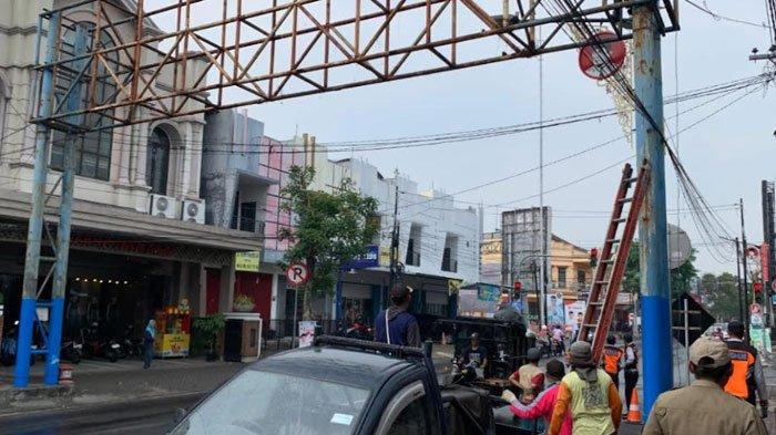Proses pembongkaran papan reklame bando di Jalan Veteran, Kota Blitar, Selasa (12/11/2024)