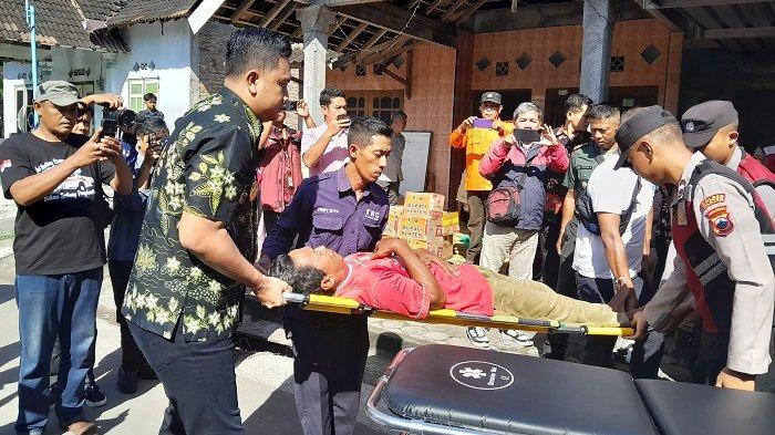 BANTU WARGA: Bupati Klaten, Hamenang Wajar Ismoyo, membantu menandu warga Desa Karangturi yang mengalami gejala keracunan makanan, sebelum dibawa ke rumah sakit menggunakan mobil ambulance, pada Selasa (15/4/2025).