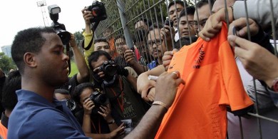 Mantan bintang sepakbola asal Belanda yang kini menjadi asisten pelatih timnas, Patrick Kluivert menyapa para penggemarnya uasi memberikan coaching clinic kepada para pemain junior Indonesia di Lapangan Asiop, Jakarta Selatan, Kamis (6/6/2013).