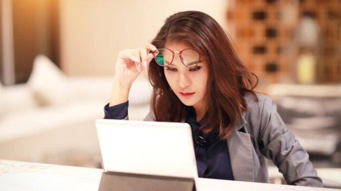 Businesswoman using digital tablet at table