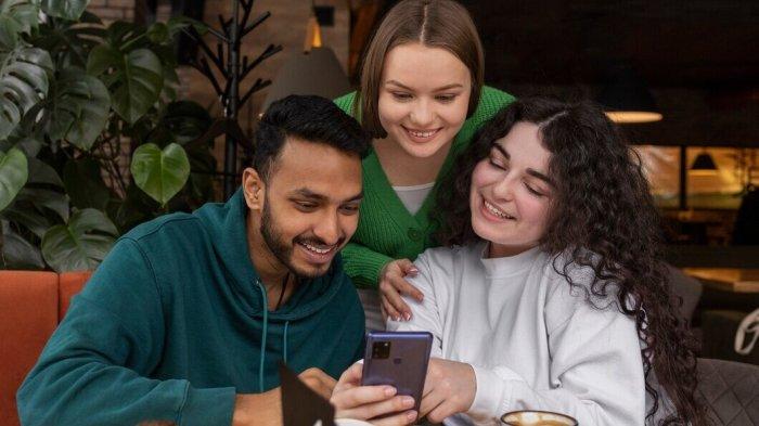 PANTUN LUCU AKHIRAN 'A' - Potret orang tertawa melihat smartphone dari Freepik.com, Rabu (9/4/2025). Simak kumpulan pantun lucu berakhiran huruf A berikut ini, lelucon kocak dijamin bikin ngakak, bahan hiburan di tongkrongan.