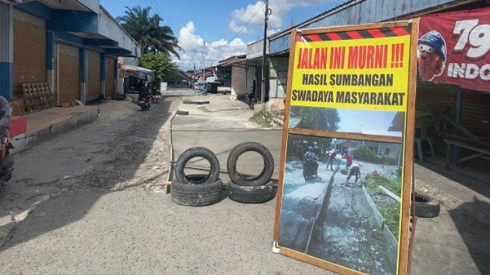 JALAN RUSAK - Kondisi jalan alternatif di Gang Suka Damai, Kecamatan Pahandut, Palangka Raya. Sebelah kiri sudah mulai diperbaiki dengan pengecoran semen, sementara sebelah kanan masih berupa jalan berbatu besar dan bergelombang yang sering menyulitkan kendaraan bermotor dan pedagang melintas, Senin (9/6/2025).