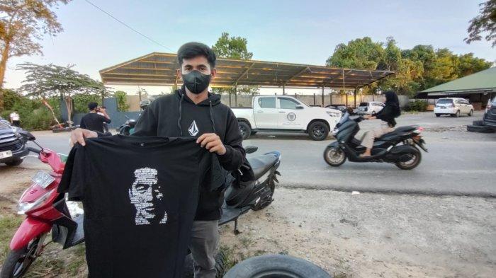 JOKOWI DI SAMARINDA - Irfan (23) salah satu warga yang beruntung mendapatkan kaos dari Presiden Joko Widodo di Samarinda Seberang, Rabu (28/2/2024). Direncanakan Jokowi akan langsung menuju Kota Bontang untuk melakukan peresmian pabrik sebelum ke IKN Nusantara, Kamis 29 Februari 2024.