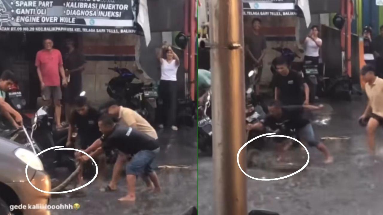 Seorang pria bersama warga sekitar di kawasan Prapatan, Balikpapan, Kalimantan Timur terpantau berusaha menjinakkan seekor ular piton pada Kamis, (6/3/2025).