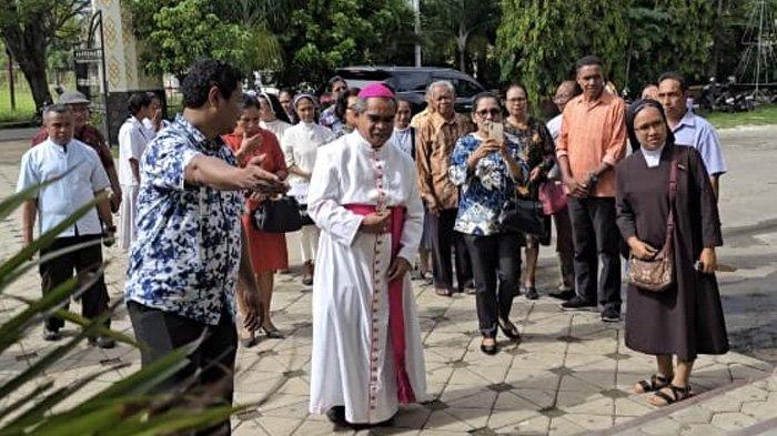 Ketua Komisi Kateketik RD. Yohanes Kartiba mengarahkan Uskup Agung Kupang. Mgr. Hironimus Pakaenoni ke pelataran gereja saat disambut para katekis di Gereja Santo Yoseph Pekerja Penfui Kupang, Jumat (13/12/2024).