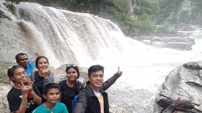 Pengunjung sedang foto di pintu jalan masuk menuju air terjun Tanggedu.