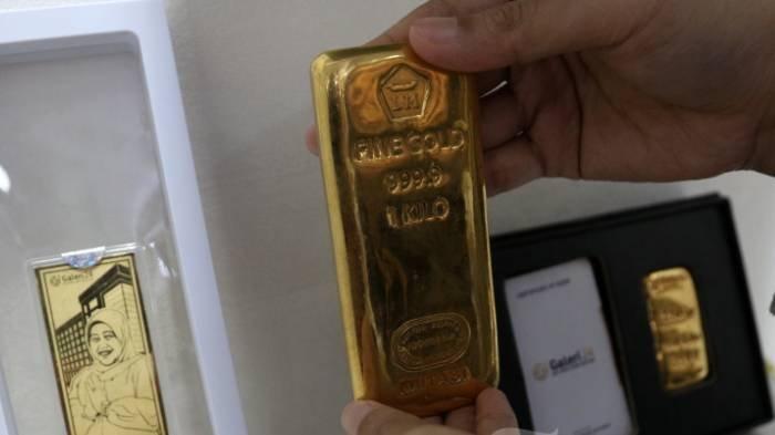 Pramuniaga menunjukkan emas batangan Aneka Tambang (Antam) di Galeri 24 Pegadaian.