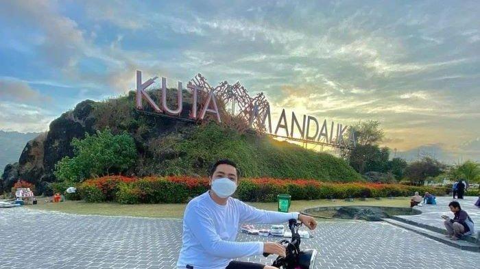 Warga bernama Gunawan saat mengendarai sepeda listrik untuk berfoto di spot instagrammable di kawasan pantai Kuta Mandalika.