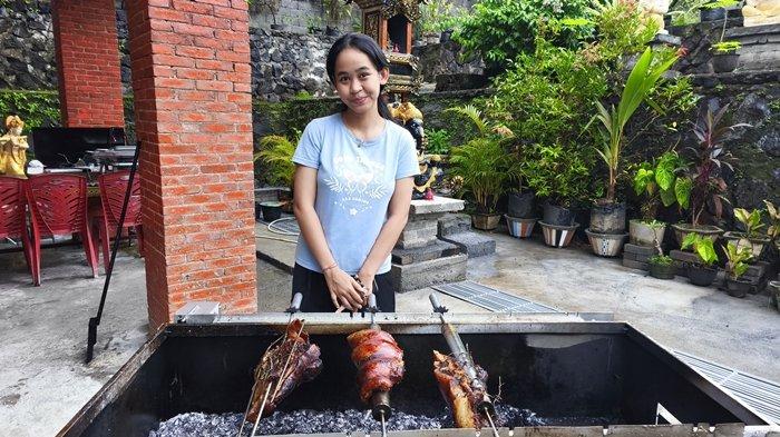 BABI GULING - Ni Nyoman Bella saat mengolah menu Babi Lapis Guling di Jalan Parigi Tujuh Kecamatan Malalayang Satu, Perumahan Dolog, Kota Manado, Sulawesi Utara.