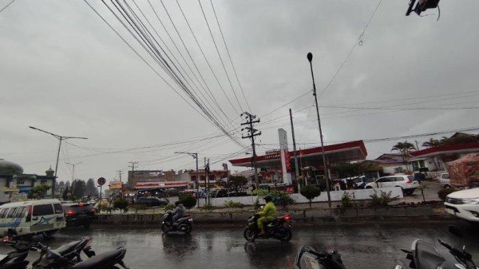CUACA BURUK: Pengendara sepeda motor mengemudikan kendaraannya sambil mengenakan jas hujan saat melintas di Jalan Jamin Ginting, Kabanjahe, Rabu (23/4/2025). Melihat cuaca buruk yang masih berlanjut, BPBD Karo mengimbau masyarakat menghindari kawasan rawan bencana. (TRIBUN MEDAN/MUHAMMAD NASRUL)