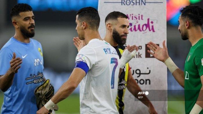 Penyerang Nassr asal Portugal #07 Cristiano Ronaldo (tengah kiri) dan penyerang Ittihad asal Prancis #09 Karim Benzema (tengah kanan) menyambut para pemain menjelang pertandingan sepak bola Liga Pro Saudi antara Al-Ittihad vs Al-Nassr di Stadion King Abdullah Sports City di Jeddah pada 26 Desember 2023. AFP (AFP)