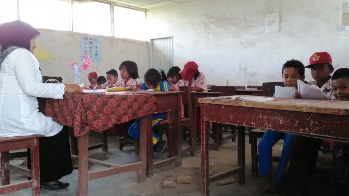Guru terlihat mengajar di ruang kelas III SDN 046417 Desa Naman, Namanteran Tanah Karo, Sumut. Ruang kelas mengalami kerusakan dan murid tidak gunakan sepatu, Rabu (18/1/2017). (Tribun Medan / Jefri)