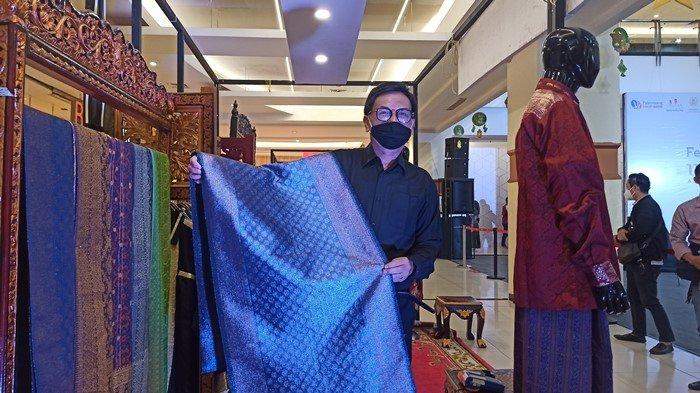 Zainal memperlihatkan salah satu songket karyanya yang dibuat dari bahan sutera.