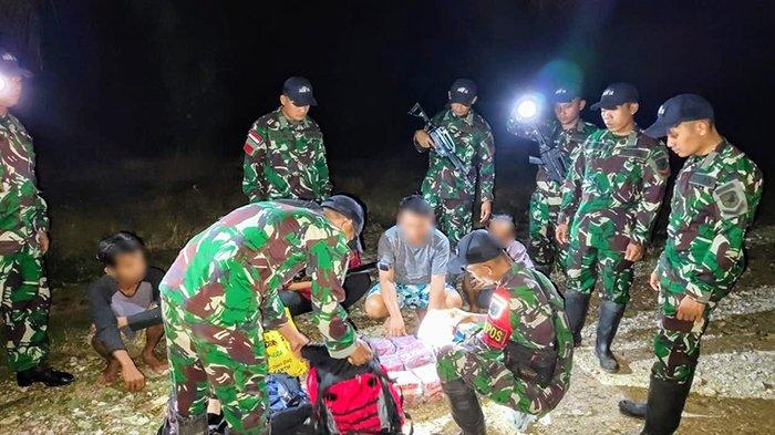 Anggota Satgas Pamtas RI-Malaysia Sektor Barat Yon Armed 16/TK saat geledah tas ransel milik 5 orang pelintas batas yang akhirnya di temukan 20 bungkus teh kemasan Guanyinwang yang diduga kuat berisikan 25,4 Kg narkoba jenis sabu pada Kamis 30 Mei 2024 dini hari di jalan kebun PT. Ledo Lestari 1 Divisi 6 Ds. Semunying Jaya Kec. Jagoi Babang Kab. Bengkayang.
