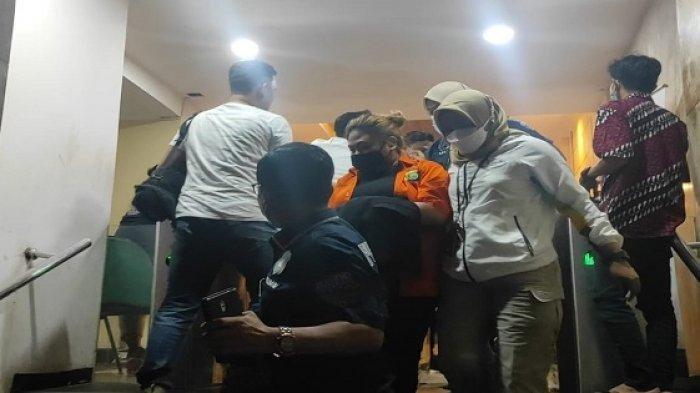 Putri Nia Daniaty, Olivia Nathania (mengenakan baju tahanan) hanya menunduk saat digiring polisi untuk dilakukan penahanan di Polda Metro Jaya, Kamis (11/11/2021).