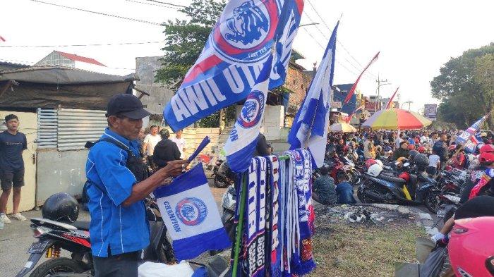Fauzan (62) berjualan merchandise Arema di Exit Tol Madyopuro, Kota Malang, Senin (5/8/2024).