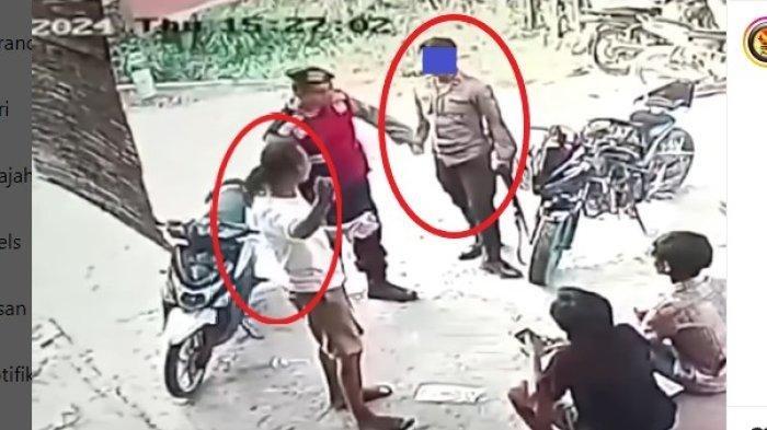 Oknum polisi menampar warga seorang pria berkaos putih