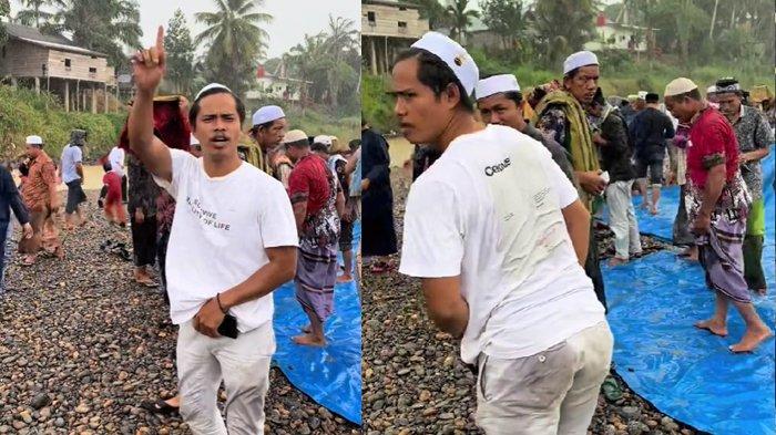 Seorang warga menunjukkan ekspresi bahagia setelah turun hujan