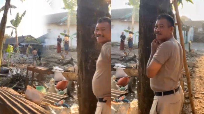 Seorang warga menyaksikan pemuda Pasuruan naik di atap rumah