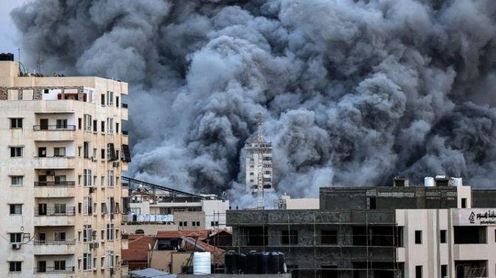 Situasi perang Hamas-Israel. Asap di atas gedung-gedung Kota Gaza pada Sabtu (7/10/2023), saat serangan udara Israel menghantam gedung Palestine Tower.