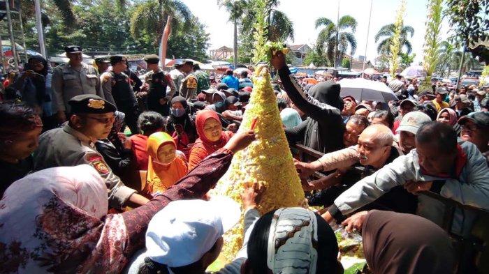 Warga berebut tumpeng di acara jamasan Gong Kiai Pradah di Alun-alun Lodoyo, Kecamatan Sutojayan, Kabupaten Blitar, Selasa (17/9/2024).