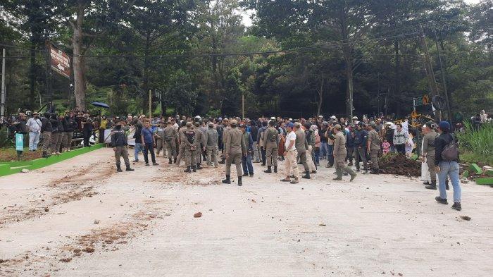HALAU MASSA - Satpol PP Jawa Barat menghalangi massa yang menuntut pembongkaran tempat wisata Hisbisc Fabtasy Puncak di Jalan Raya Puncak, Kecamatan Cisarua, Kabupaten Bogor, Jawa Barat, Jumat (7/3/2025). Tempat wisata milik BUMD Jawa Barat ini dibongkar karena melanggar tata ruang.