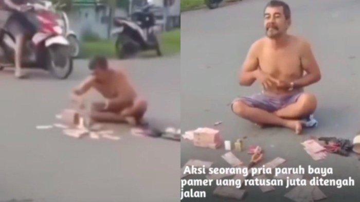 Pria pamer uang di tengah jalan