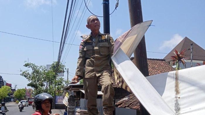 Dinas Satpol PP Gianyar menertibkan baliho dan spanduk yang melanggar Perda, Jumat 20 Oktober 2023.