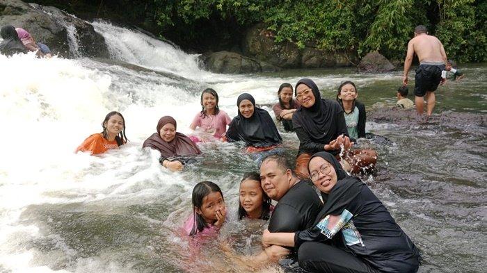 Hendra bersama keluarga merayakan Tahun Baru 2024 di Jeram Alam Roh 17 di Desa Rantau Bujur, Kecamatan Aranio, Kabupaten Banjar, Senin (1/1/2024).