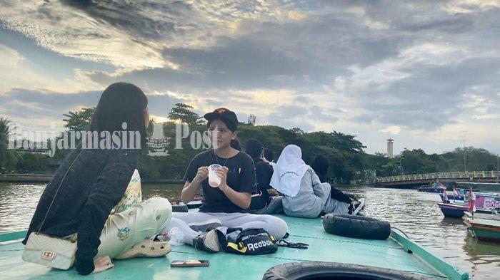 Wisatawan sedang menikmati Wisata Susur Sungai Martapura atau Wisata Kelotok di Banjarmasin, Kalimantan Selatan pada Selasa (21/5/2024) sore.