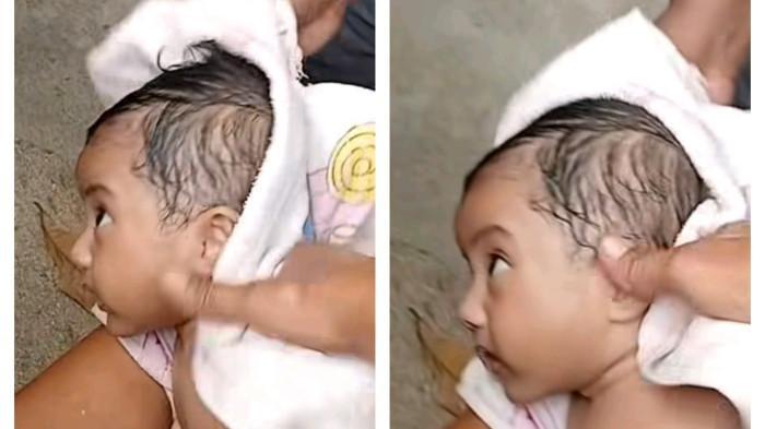BAYI SELAMAT - Seorang bayi selamat dalam kecelakaan KM Barcelona VA di Perairan Pulau Talise, Kabupaten Minahasa Utara, Minggu (20/7/2025). Orang tua bayi tersebut berada di Desa Serei.