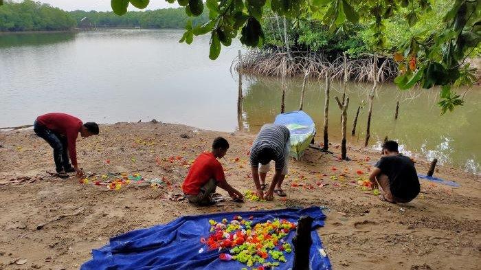PENCURIAN DI BATAM - Pekerja dan pemilik usaha Arina Florist mengambil sisa papan bunga yang ditemukan di bawah Jembatan Nongsa Pura, Rabu (8/11/2023). Papan bunga milik mereka yang terpasang di PN Batam pesanan simpatisan warga Rempang sebelumnya hilang, Senin (6/11/2023).