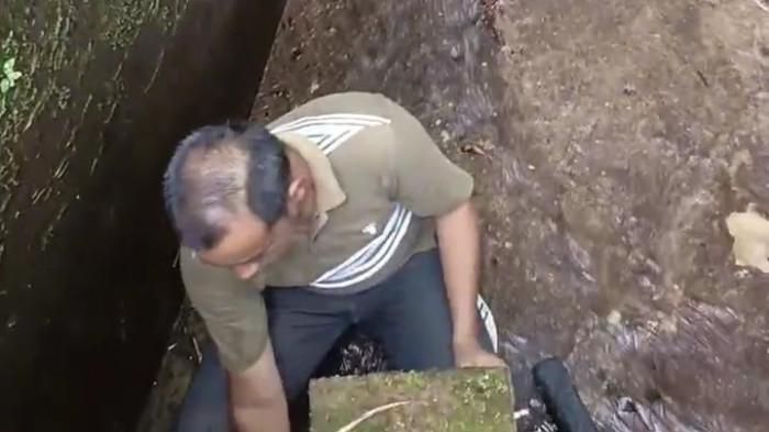 BERSIHKAN TANGKAPAN AIR - Petugas UPTD SPAM Anambas tengah melakukan pembersihan di sumber mata air dan tangkapan air (intek) di sumber mata air Batu Tabir, Desa Tarempa Selatan, Anambas, Kepri, Minggu (27/7/2025)