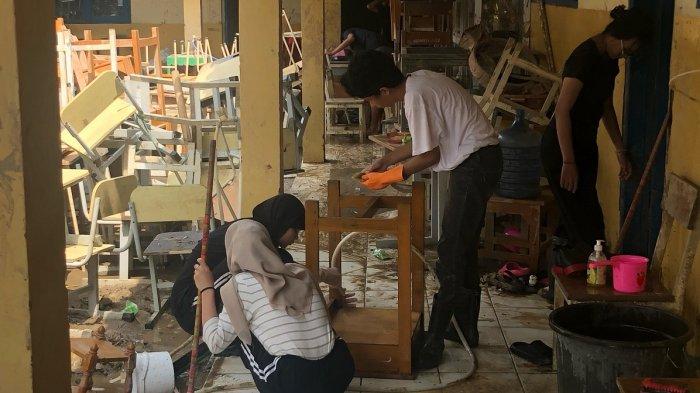 BANJIR KOTA BEKASI - Kondisi terkini di SMA Negeri 21 Bekasi, Jalan Muara Raya RT 06 RW 09, Kecamatan Jatiasih, Kota Bekasi pada Senin (10/3/2025). Para murid diberikan tanggung jawab membersihkan ruang kelasnya masing-masing dari kotoran lumpur imbas banjir.