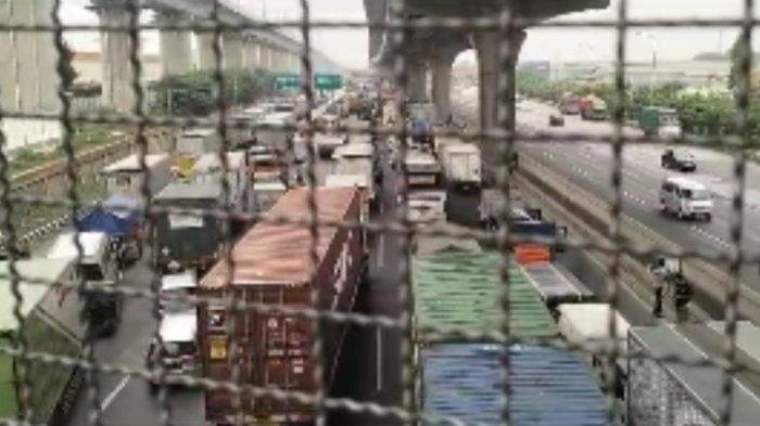 Massa buruh melakukan pemblokiran jalan kawasan industri MM2100 di Cikarang Barat, Kabupaten Bekasi, Jawa Barat pada Kamis (23/11/2023) pagi. Pemblokiran jalan itu berimbas pada kepadatan arus lalu lintas di Tol Jakarta-Cikampek.