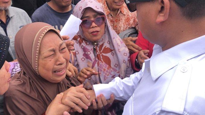 MENANGIS HARU --- Mursiti, korban eksekusi pengosongan lahan sengketa di kawasan Desa Setia Mekar, Kecamatan Tambun Selatan, Kabupaten Bekasi menangis haru dan berterima kasih kepada Menteri ATR/BPN Nusron Wahid yang menemui para korban eksekusi pengosongan lahan, Jumat (7/2/2025). Mursiti terlihat mencium hingga memeluk Nusron Wahid yang membela warga.