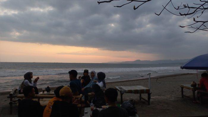 Sejumlah wisatawan terlihat asyik nongkrong di Pantai Citepus sambil menikmati keindahan sunset, Kamis (12/9/2024).