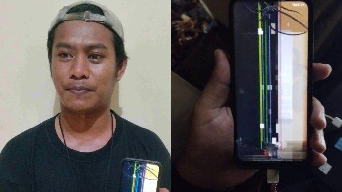 Ridha Yansa wartawan RTV menunjukkan handphone miliknya yang rusak, Senin (23/12/2024).