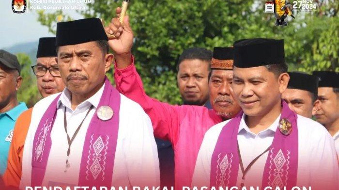 PENDAFTARAN: Foto pasangan Roni Imran dan Ramdan Mapaliey menjadi yang pertama mendaftar dan diterima oleh Ketua dan Anggota KPU di Aula RPP Saronde KPU Kabupaten Gorontalo Utara.