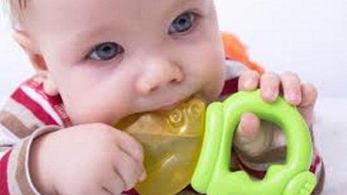 Ilustrasi bayi yang mengigit teether untuk mengurangi rasa sakit saat tumbuh gigi