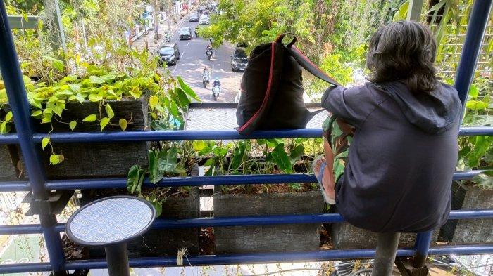 Warga duduk di kursi untuk beristirahat sejenak di jembatan penyeberangan orang (JPO) sambil menyaksikan lalu lintas kendaraan, di Jalan Wastukencana, Kota Bandung, Jawa Barat, Senin (18/9/2023).