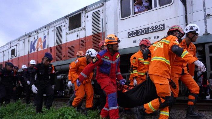 Petugas membawa kantung berisi mayat salah satu korban yang berhasil dievakuasi dari gerbong kereta api (KA) Lokal Bandung Raya yang bertabrakan dengan KA Turangga di Desa Cikuya, Kecamatan Cicalengka, Kabupaten Bandung, Jawa Barat, Jumat (5/1/2024).